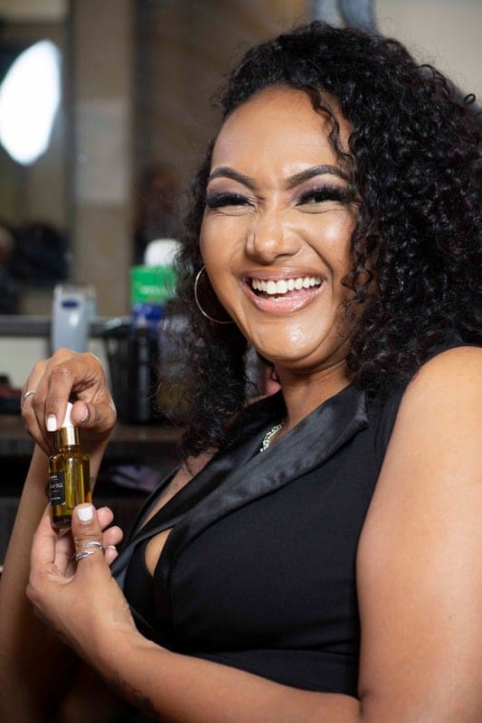 JB holding her signature oil blend