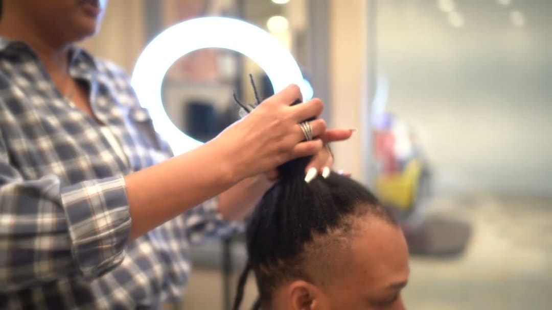 JB retwisting a client's locs